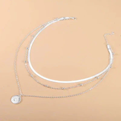 Layered silver necklaces with coin pendants – elegant and modern design
